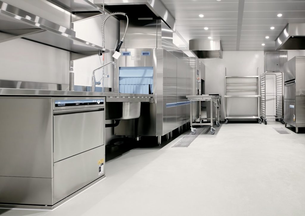 Stainless steel commercial kitchen with a dishwashing station