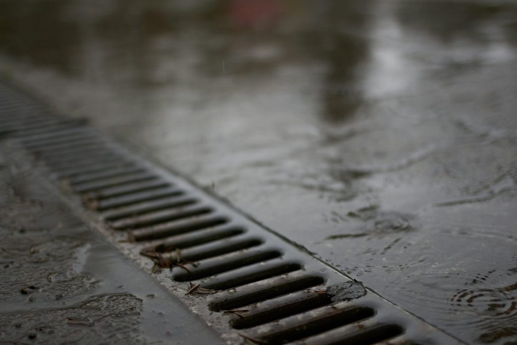 Metal drain channel on wet concrete