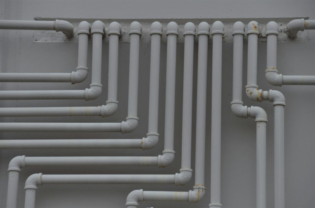 Network of pipes running along a wall