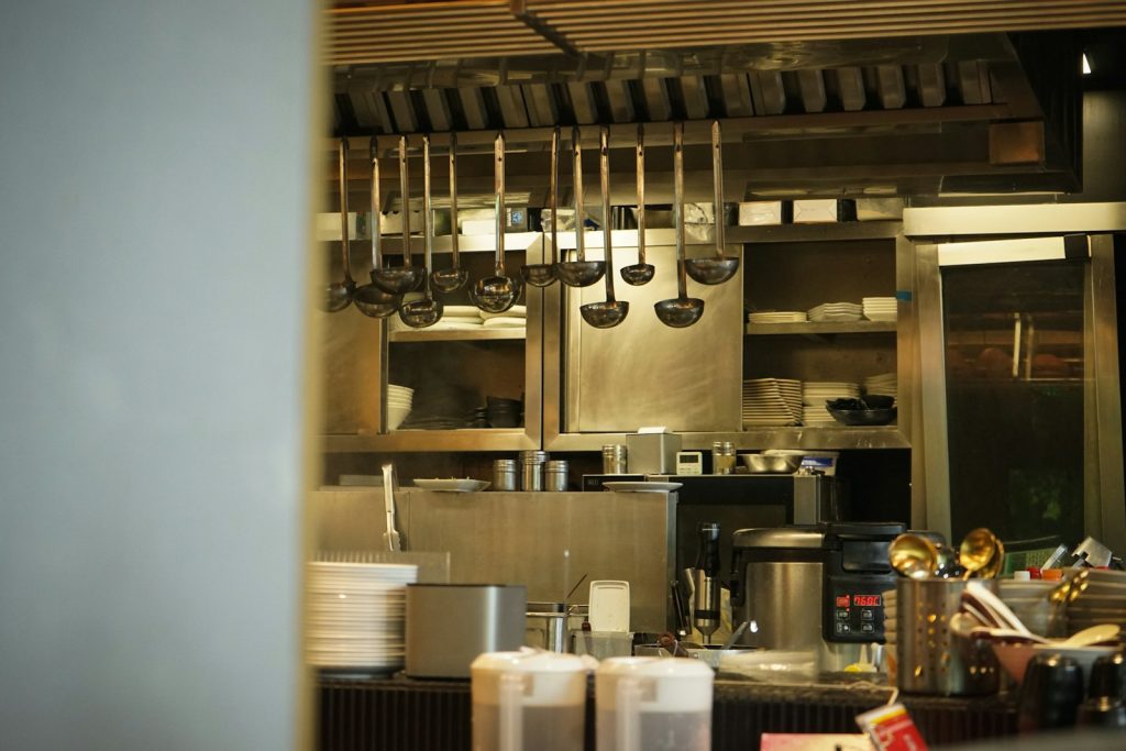 Professional kitchen with hanging utensils