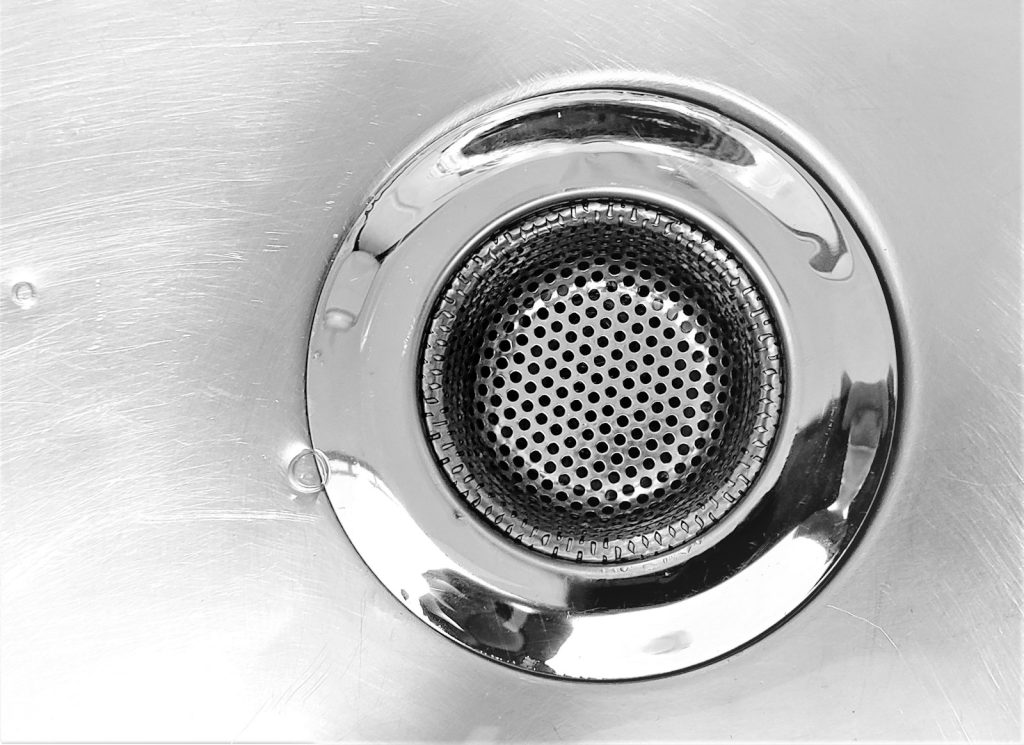 Close-up of a metal sink drain strainer