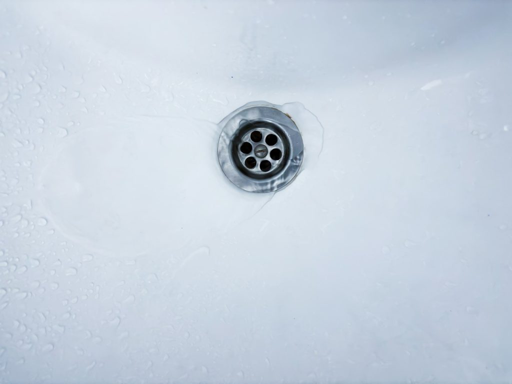 Water draining freely from a white basin